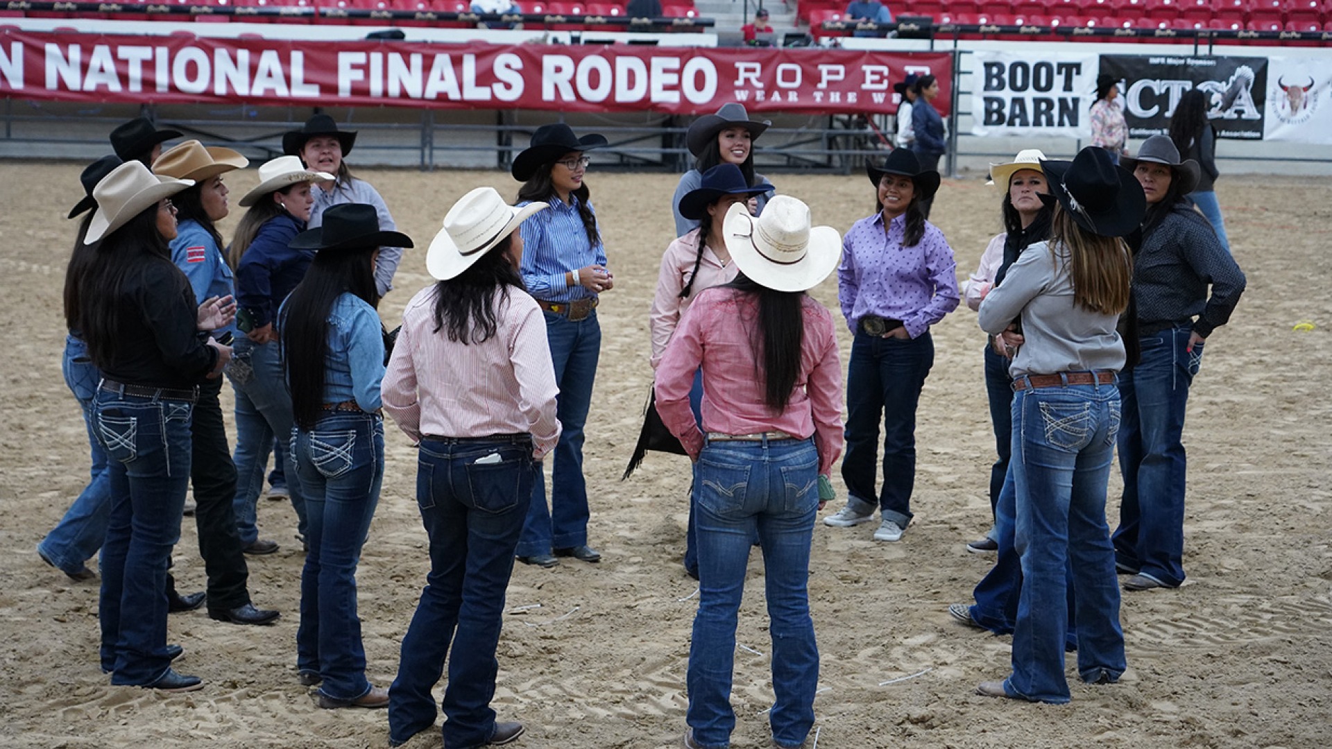 A photograph taken at the Rodeo. A group of people stand in a circle.